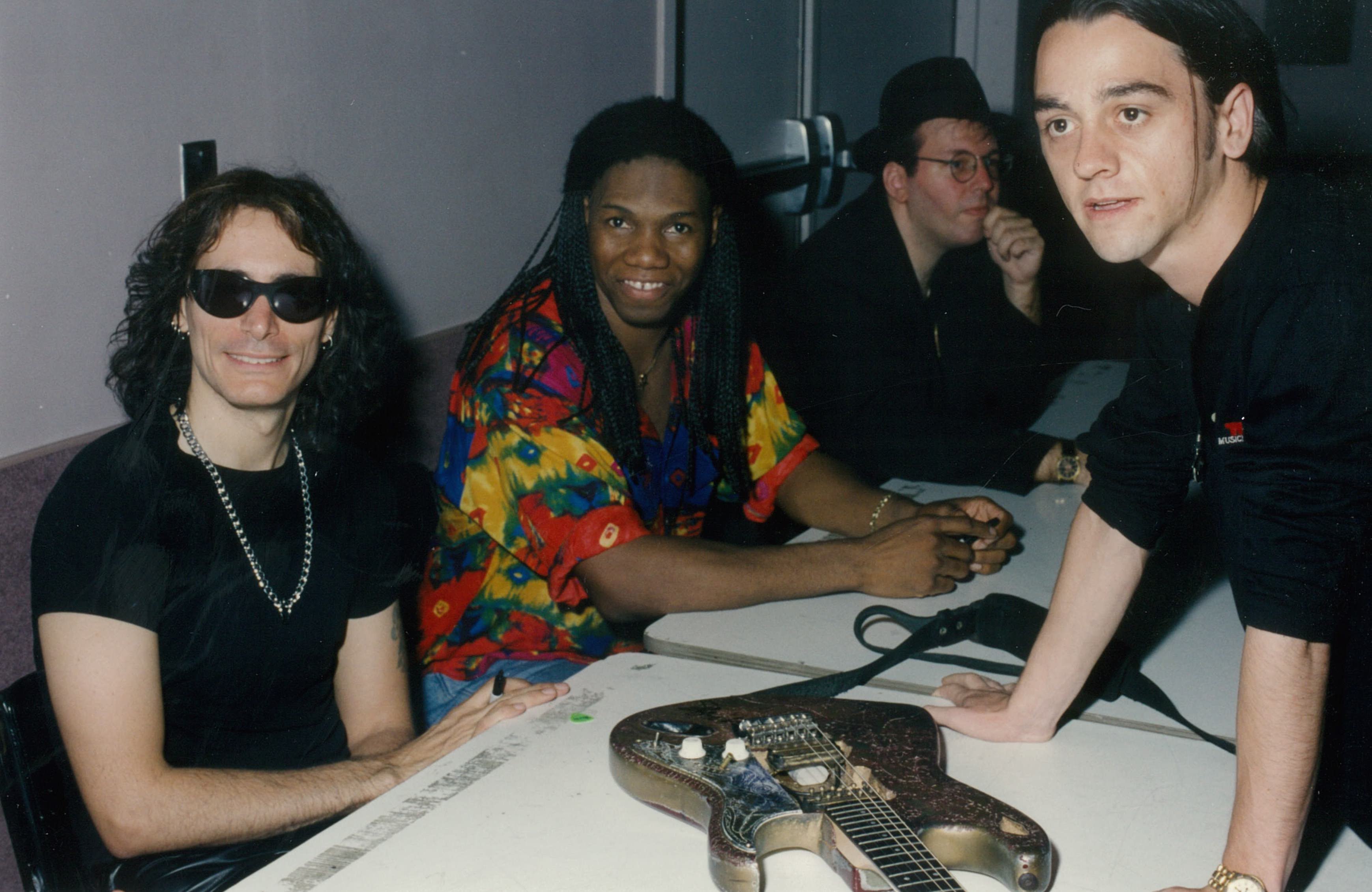 Steve Vai autographing guitar