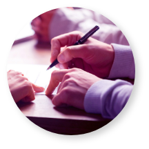 hands shown about to write on a paper with a pencil